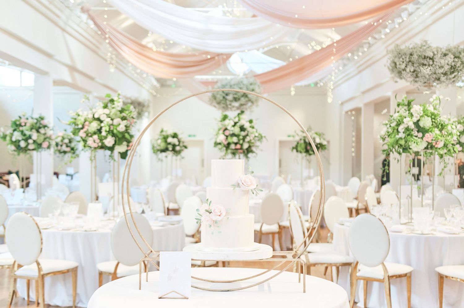 stunning luxury pink and white with hints of gold wedding reception at luxury Norfolk wedding venue Holkham Hall.