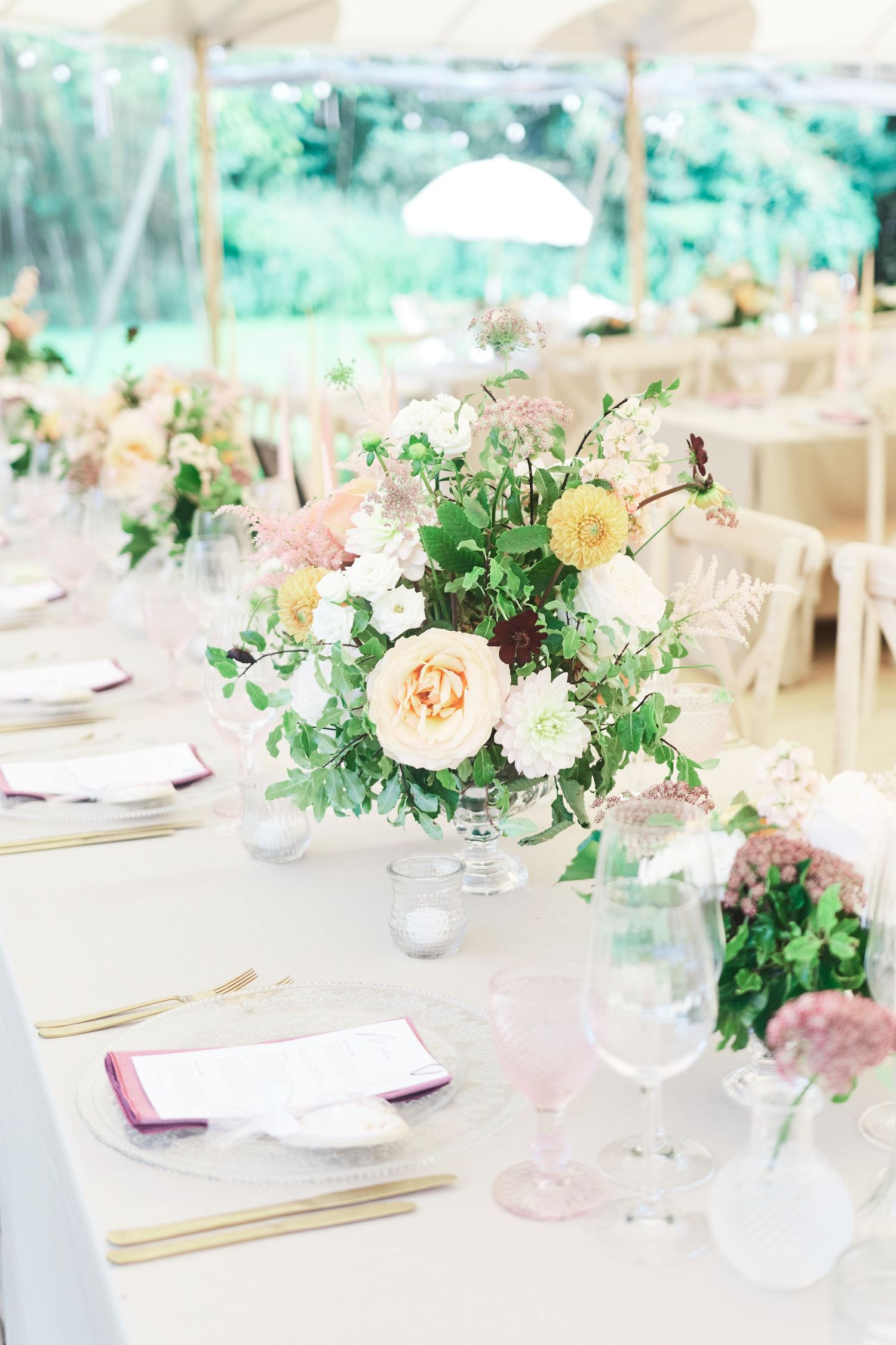 luxury garden wedding reception with pastel peach florals in Essex. Award winning Norfolk wedding photography Faye Amar