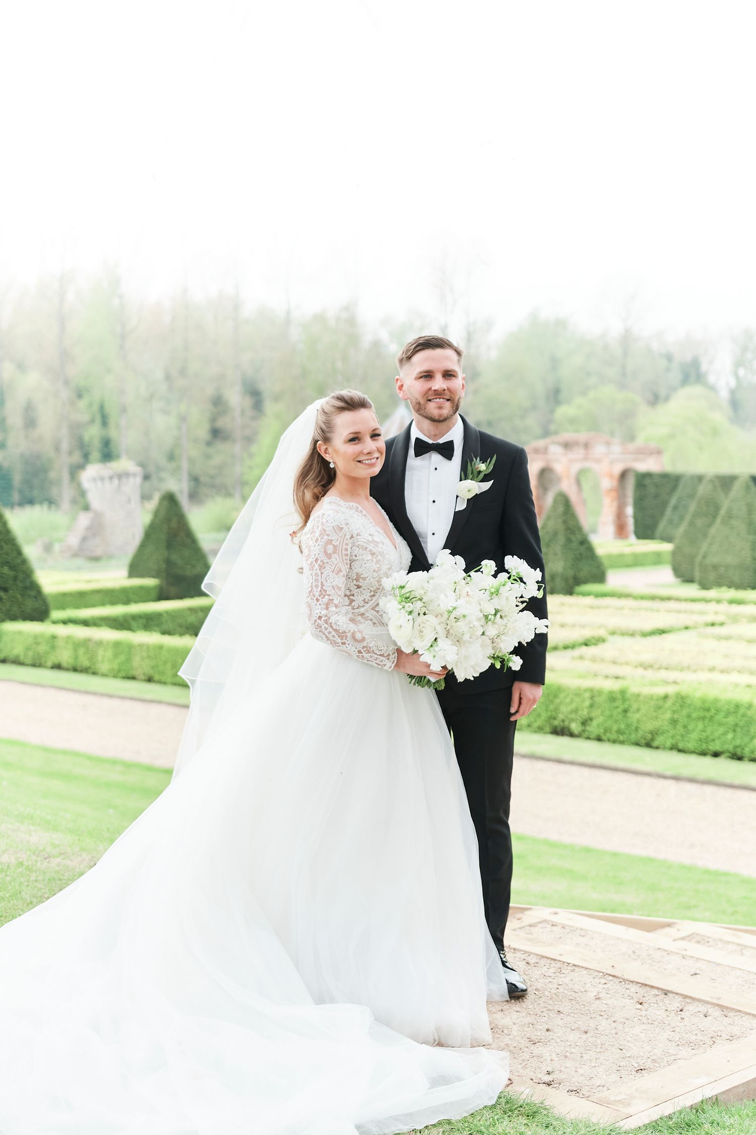 bride and groom portraits in gardens at luxury Oxnead Hall wedding. by Norwich's best wedding photographer Faye Amare