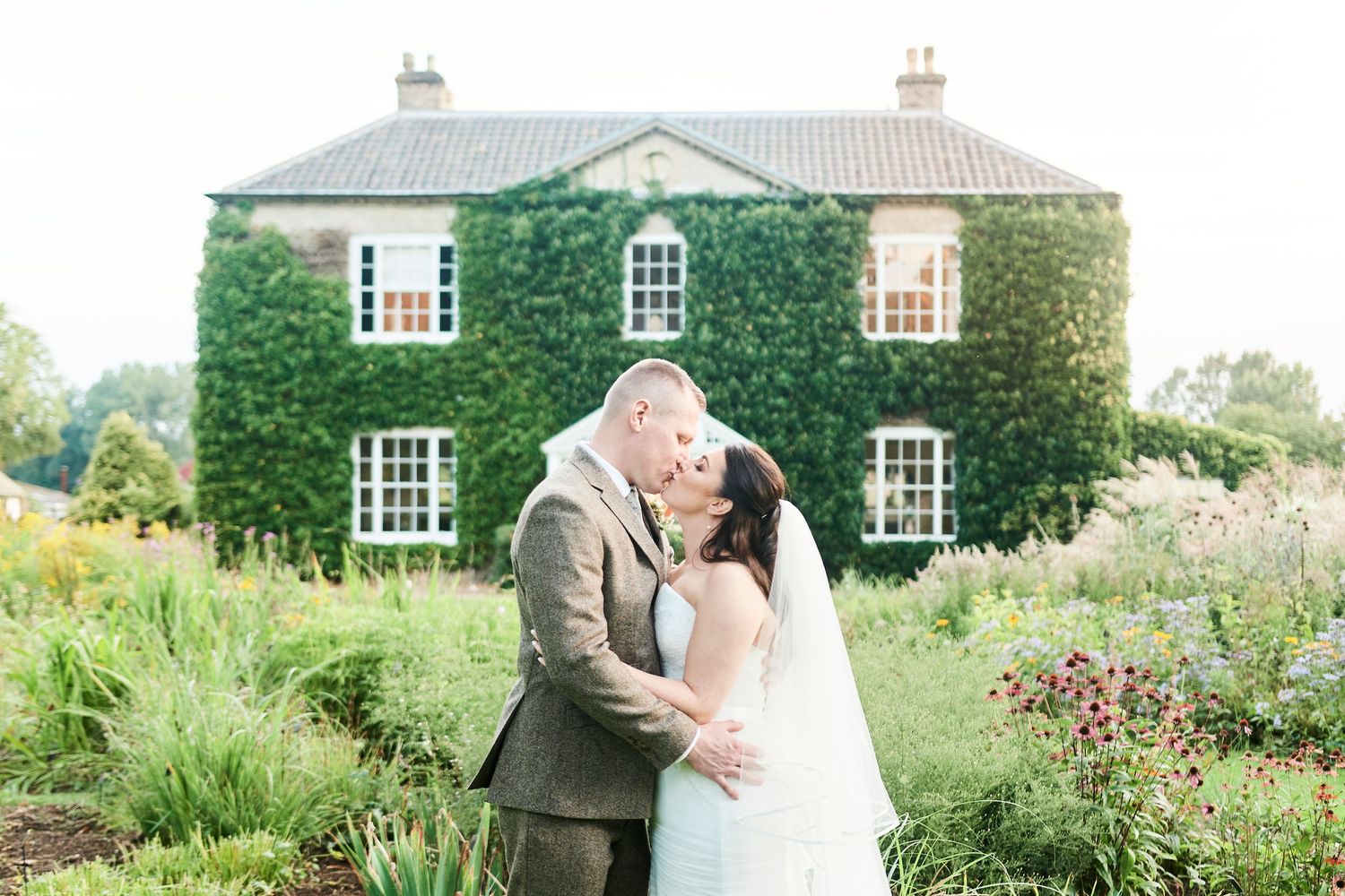 bride & groom portrait in gardens at luxury Bressingham Hall wedding by Norfolk's best wedding photographer Faye Amare