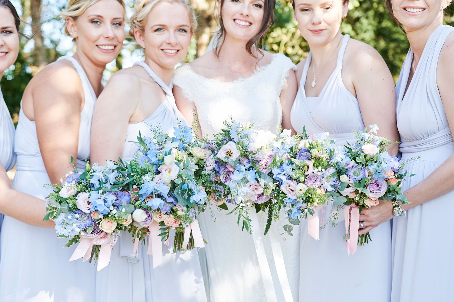 norfolk wedding photographer photographs bride with 5 bridesmaids in lilac dresses with a pastel wedding theme