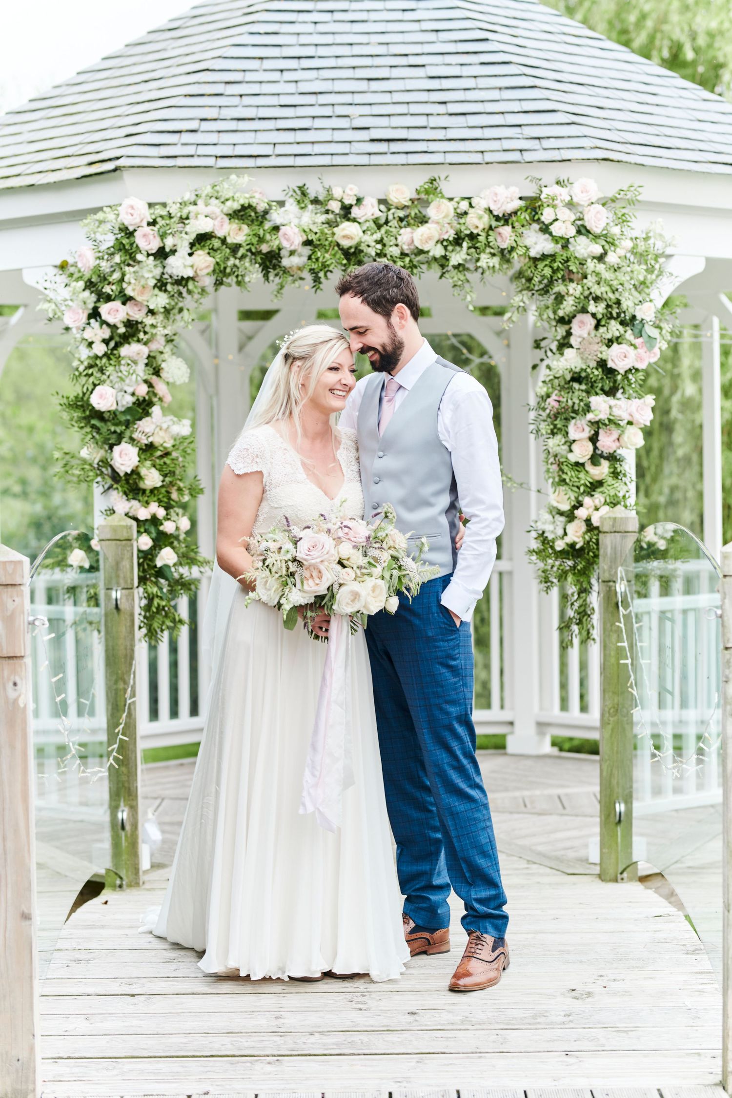 wedding guests applaud couple after wedding at The Boathouse. by award winning Norwich wedding photographer Faye Amare